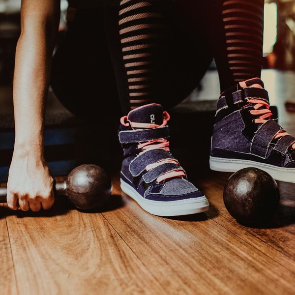 Dumbbells lying on a dark rubber gym floor.